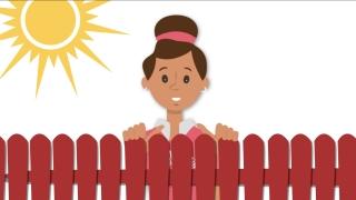 Ruby smiling behind a red fence with the sun shining