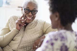 Two older black women smiling and laughing