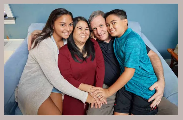 joe and his family smiling