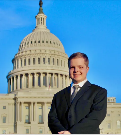 Gus Robertson smiles in front of the U.S. Capitol.