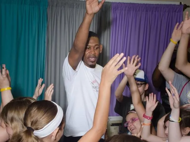 Middleweight boxing champion Daniel Jacobs interacts with a group of children