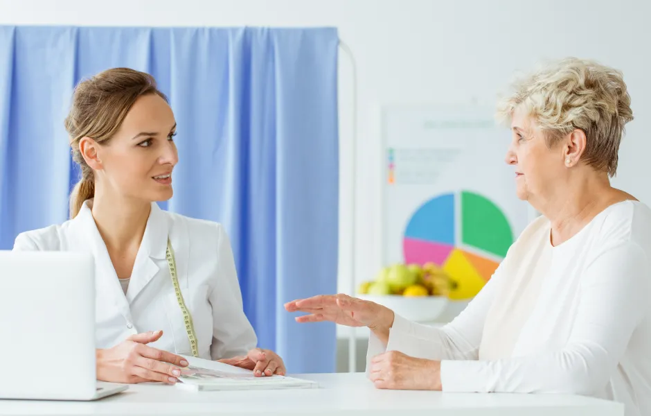 A woman talks with a registered dietitian in her office