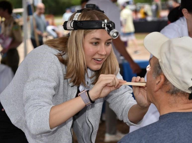 A volunteer doctor conducts a visual exam at a screening event hosted by the Head and Neck Cancer Alliance