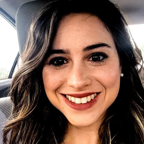 Alyssa smiles from inside her car