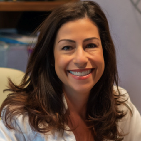 Marcia Donziger, CSC Chief Culture Office, smiles at her office desk