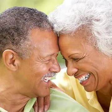 older black couple looking into each other's eyes and smiling