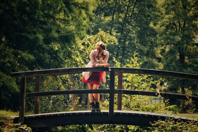 Fatigued girl on a bridge