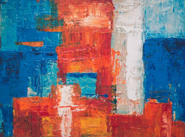 abstract artwork with red, orange, blue, and white paint