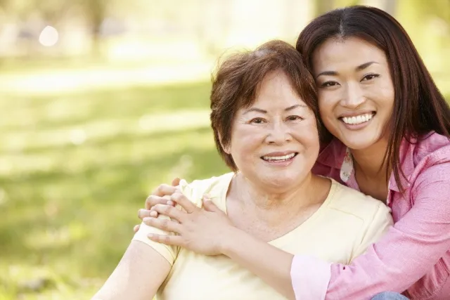 Mom and daughter hugging and smiling