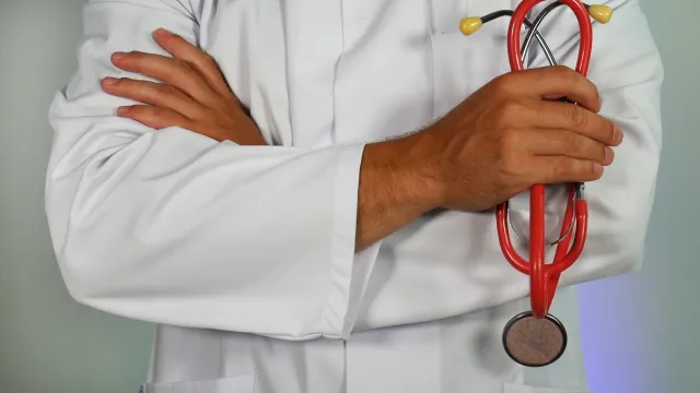 doctor with arms folded across his chest