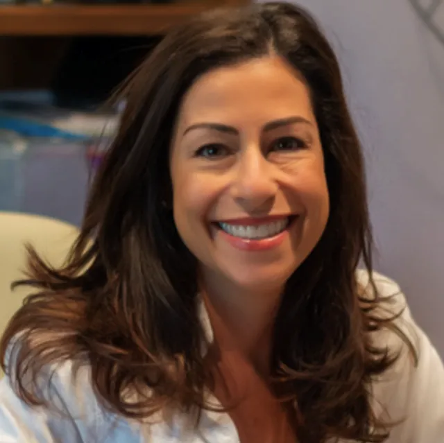 Marcia Donziger, CSC Chief Culture Office, smiles at her office desk