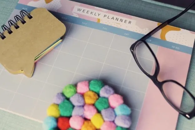 Glasses and a journal on a desk