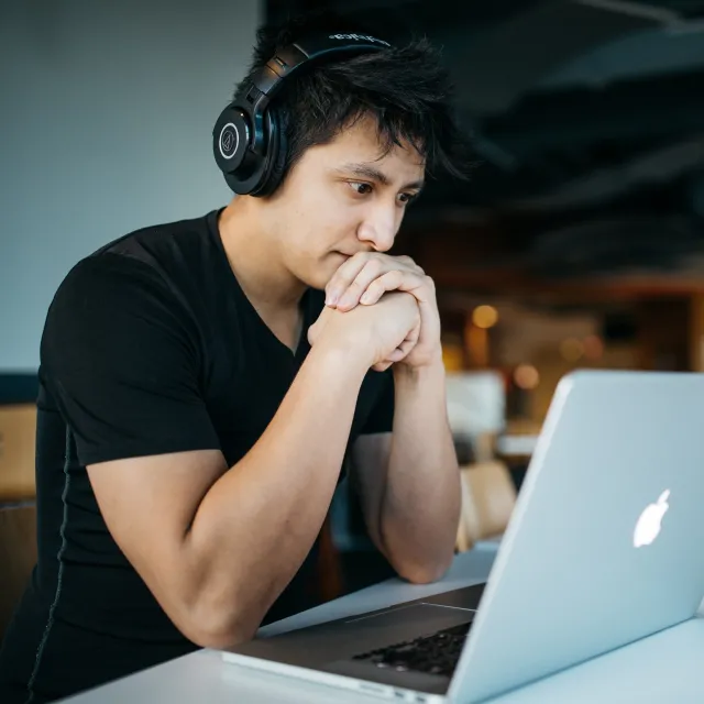 a young man at a laptop
