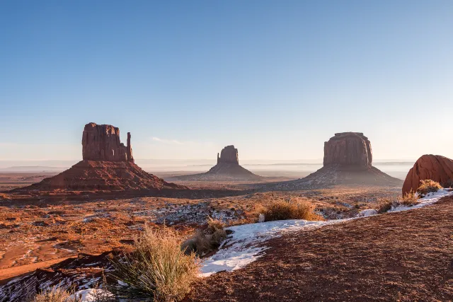 Red sandstone buttes under a blue sky in Monument Valley on the Navajo Nation 