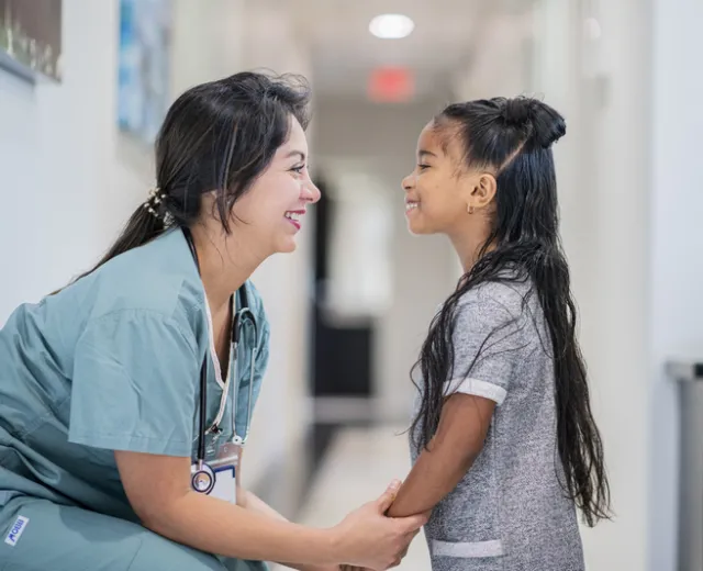 A nurse comforting a child