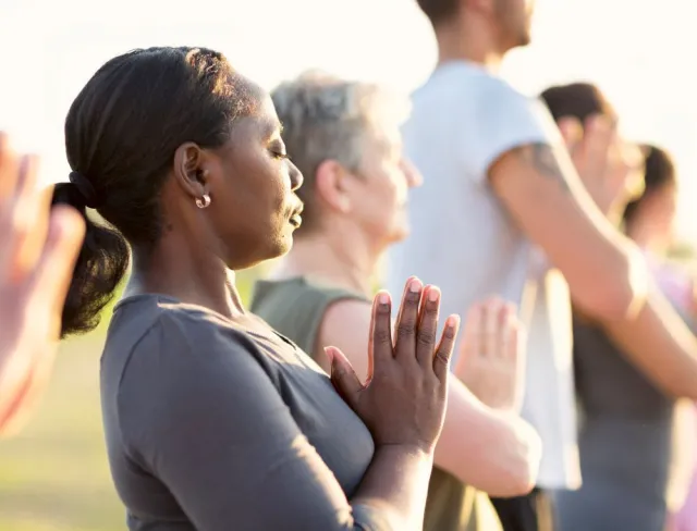 women and men practicing yoga