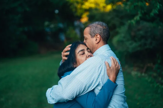 a man and a woman warmly embrace