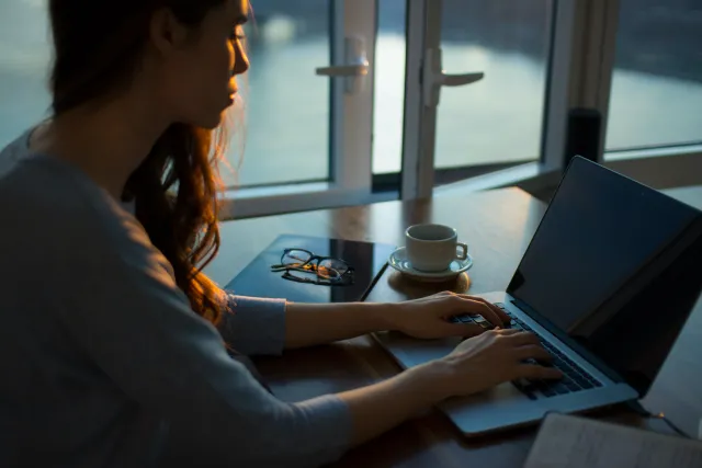 a young woman using a laptop on a table