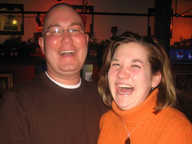 Justin and Kelly laugh together during an evening out with friends in 2008