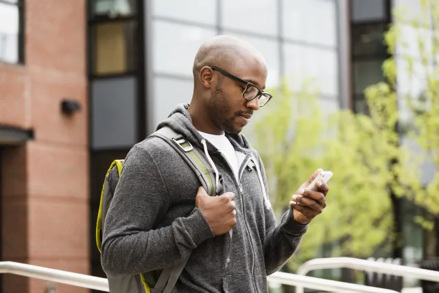 a black man using a smart phone