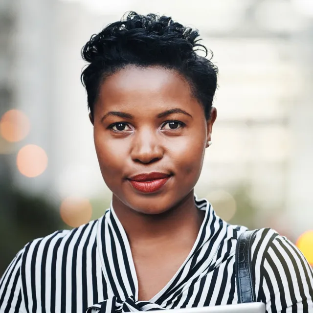 a woman with a slight smile standing facing the camera