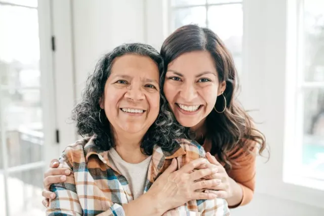 Two women smile at the camera