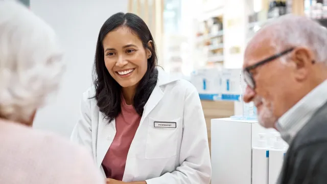 A middle aged female doctor and two patients
