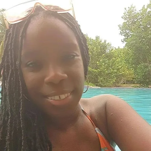 Jawanna smiles outside in Grenada