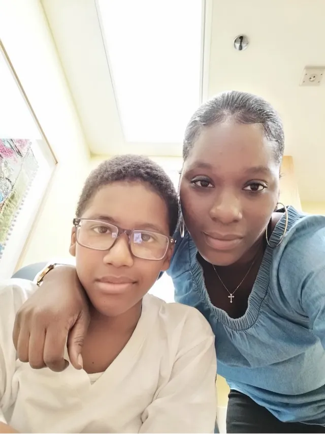 A mother with her arm around her son