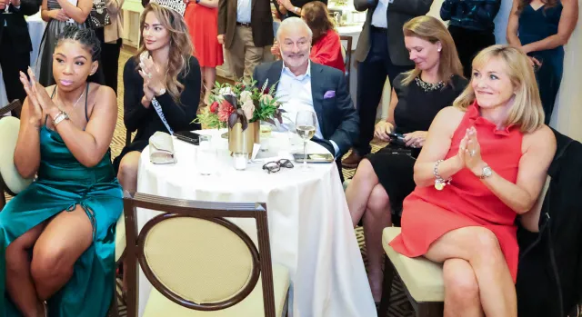 People sitting at an event table