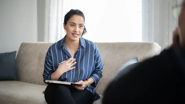 Woman sitting on couch talking