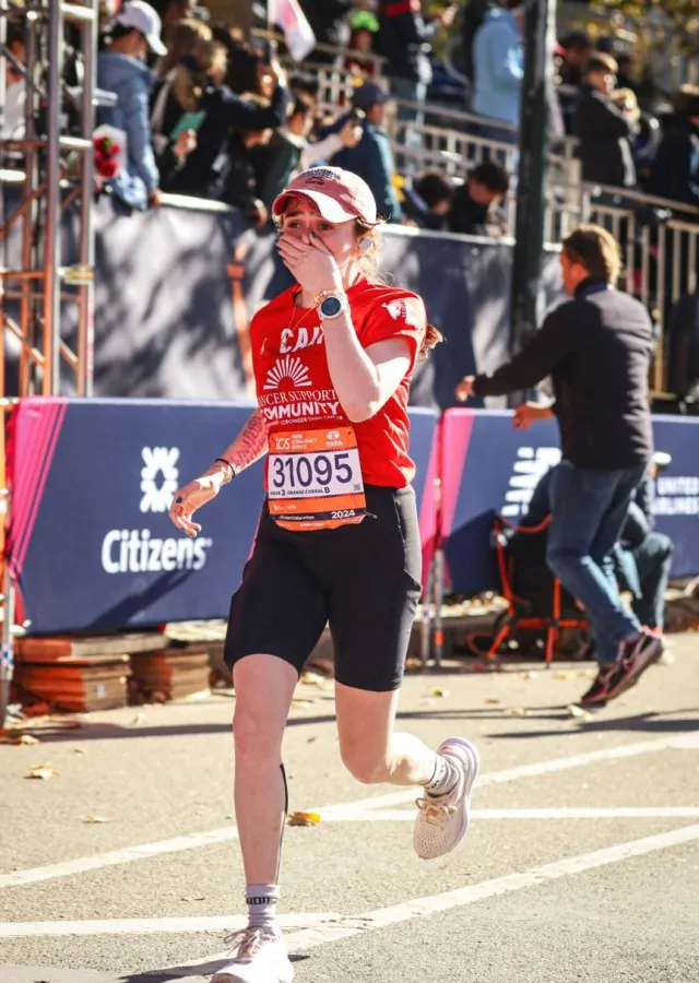 A girl running to the finish line of a marathon