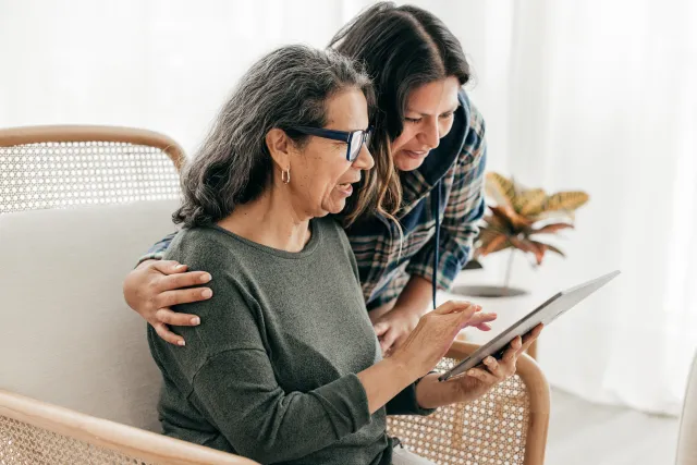 Two women viewing tablet