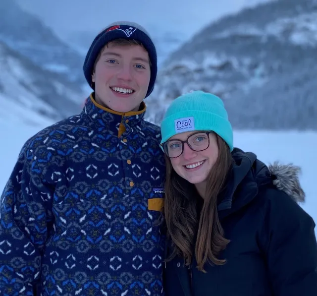 Patrick and Kacey smile in a snowy landscape