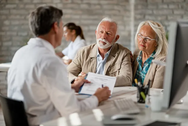 Senior couple consulting with doctor