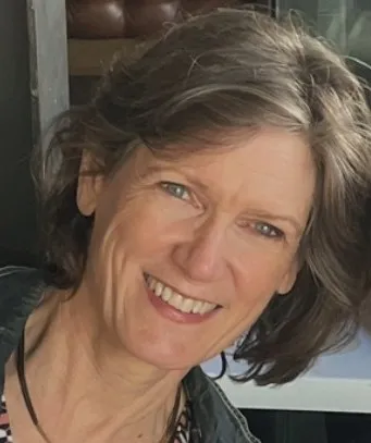 A photo of Lee, smiling