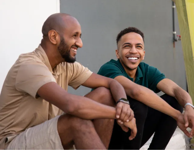 two men sitting outside