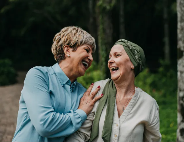 Two women laughing outside 