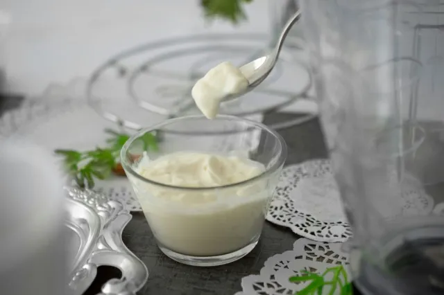 A glass cub filled with plain yogurt