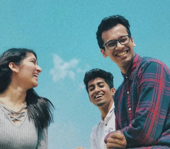 3 people standing together outside