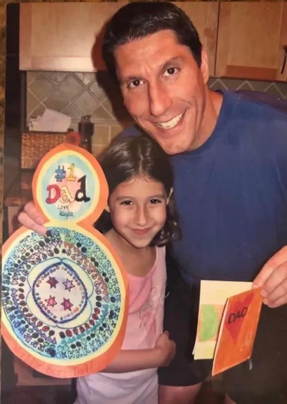 Kayla as a child with her father