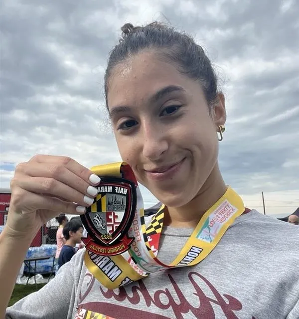 Kayla smiles for a picture after completing a half-marathon