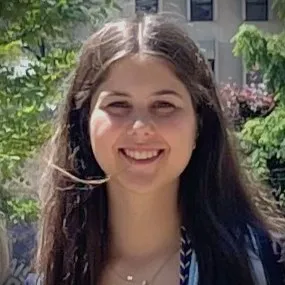 A headshot of Meghan smiling at graduation ceremony