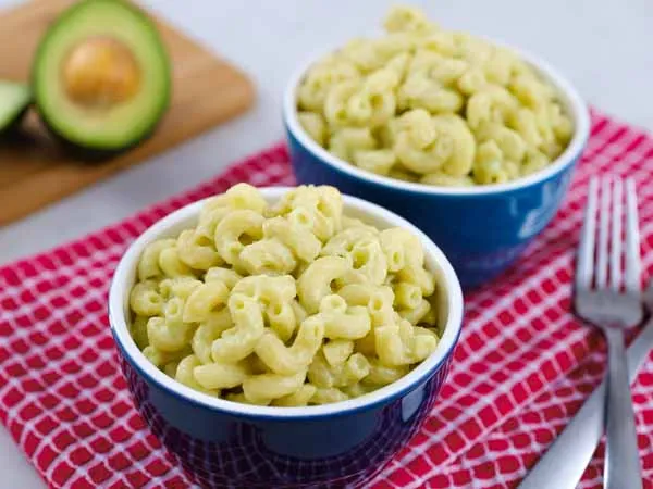 avocado mac and cheese in blue ceramic bowls