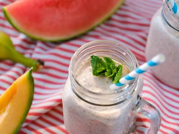 banana melon smoothie in a jar with a straw