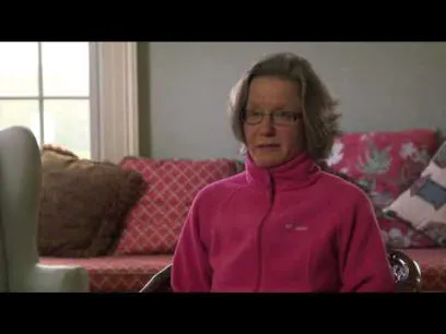 older white woman in pink jacket talking about how meditation and yoga helped her