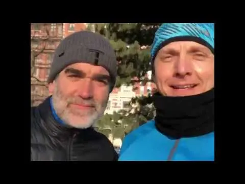 two white men in winter clothes smiling 