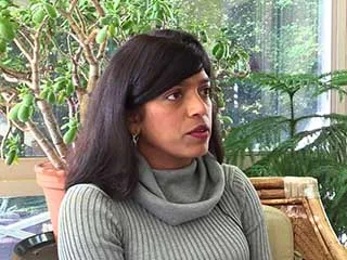 Woman in gray sweater speaking about melanoma