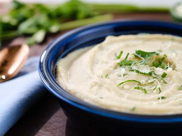 roasted cauliflower soup in a blue ceramic bowl