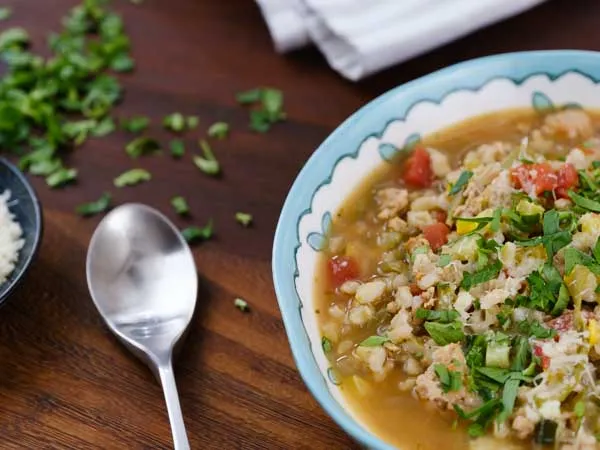 turkey barley veggie soup on a table with a spoon